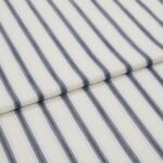 A close-up, angled view of folded fabric featuring a classic blue and white ticking stripe pattern.